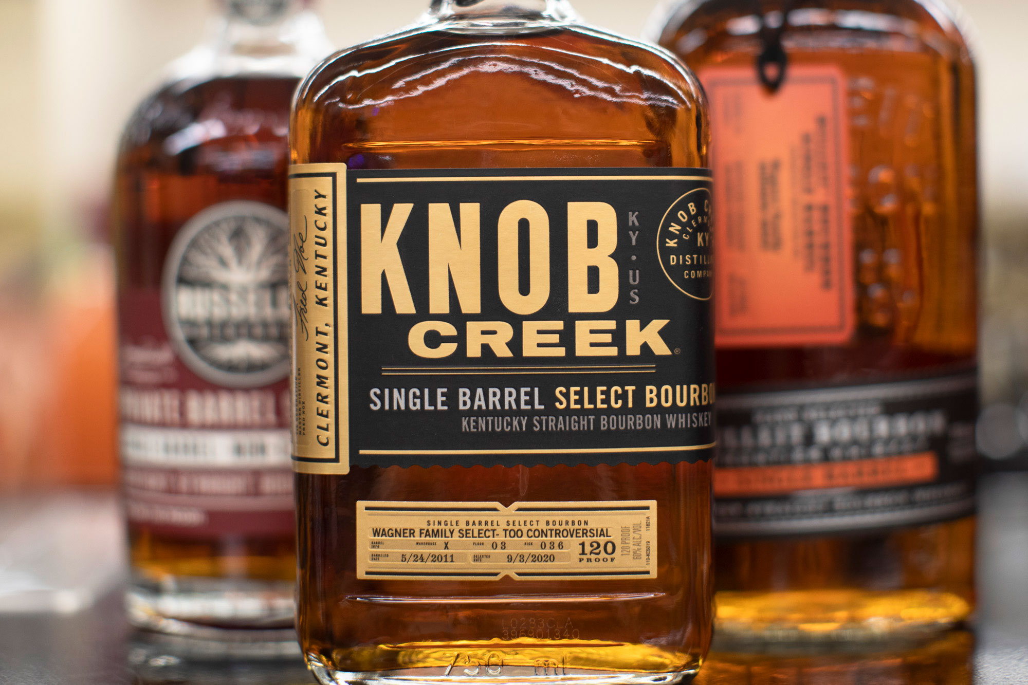 Knob Creek bourbon with Bulleit and Russells Bourbon in background