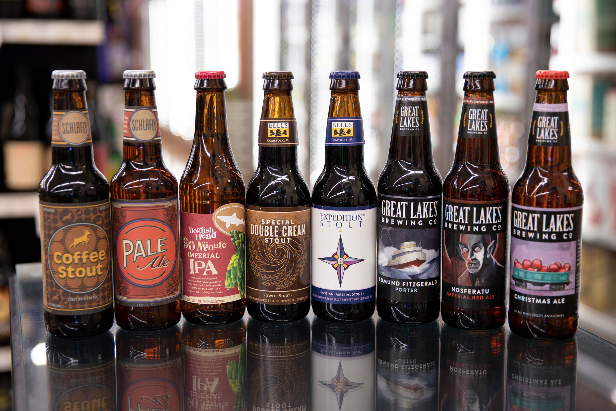 various types of craft beer bottles lined up in a row