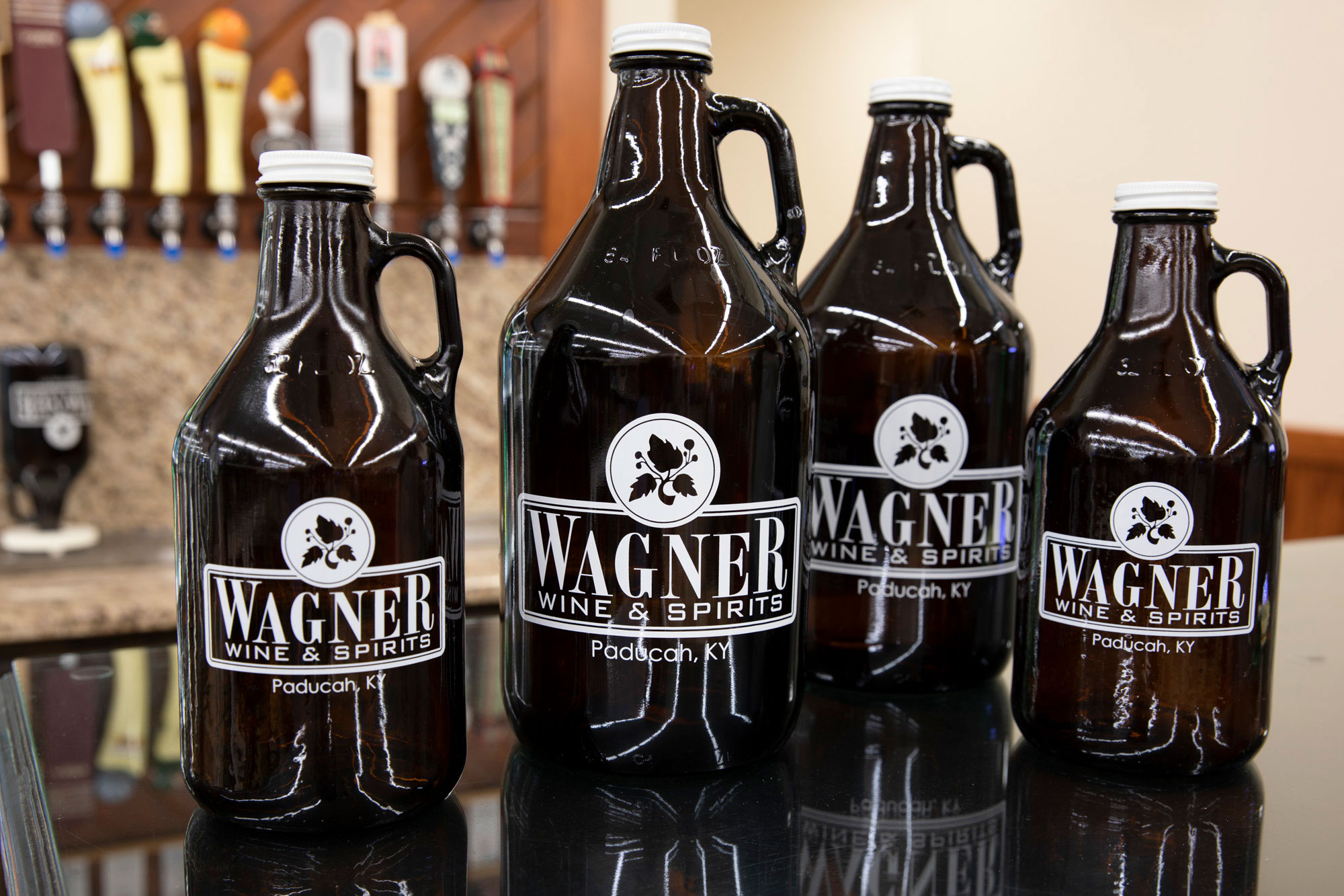 Wagners growlers lined up in front of the craft beer taps